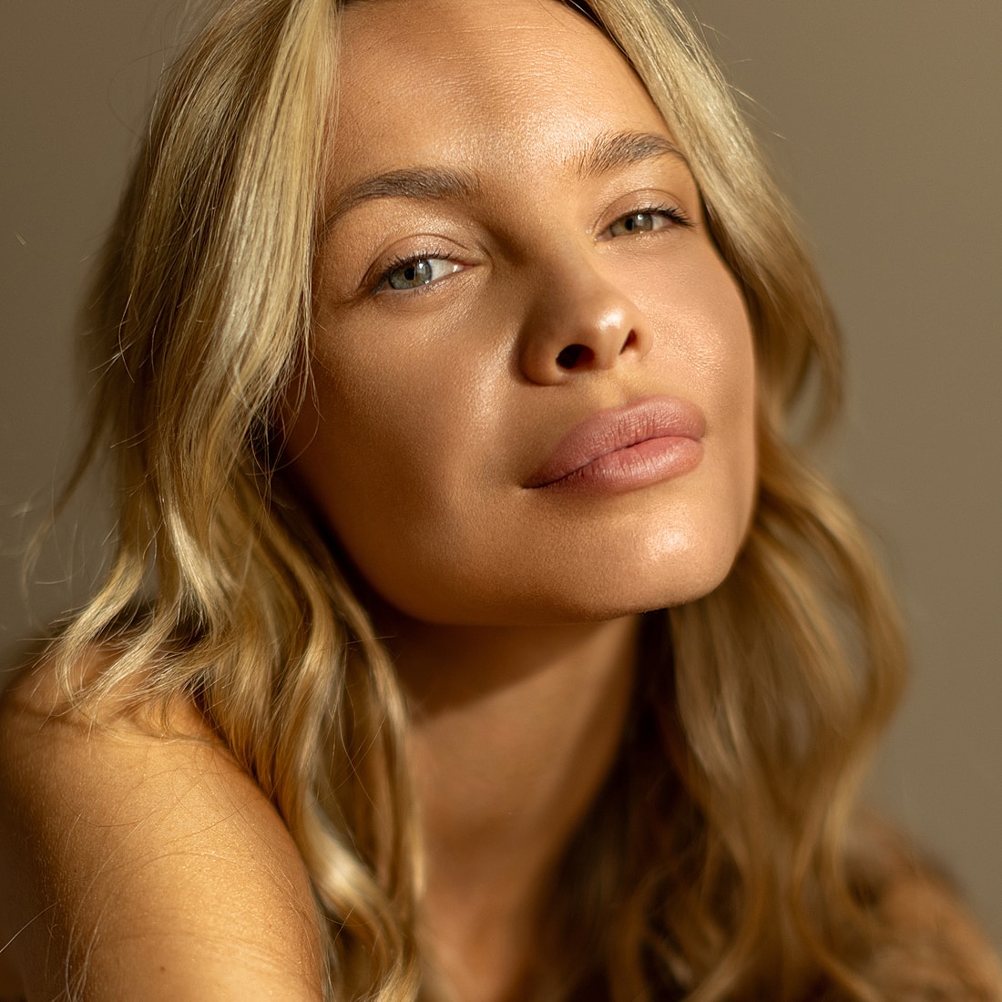 Close-up of a Lafayette facial plastic surgery model with glowing skin.